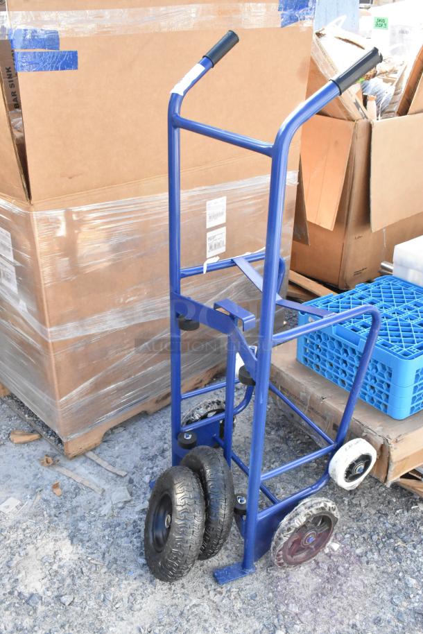 Alt text: New blue metal barrel dolly with black handles and four wheels, marked "scratch and dent."