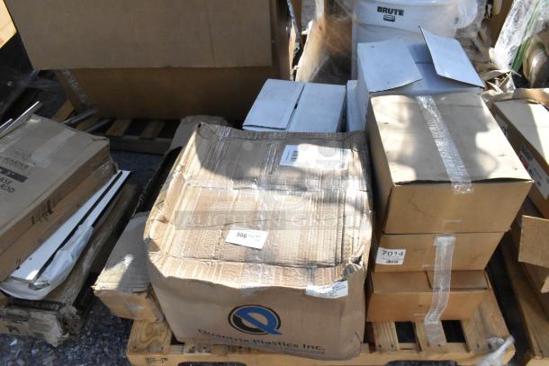 Boxes of new items, including hot dog holders and anti-fatigue floor mats, labeled "7014," on a wooden pallet.
