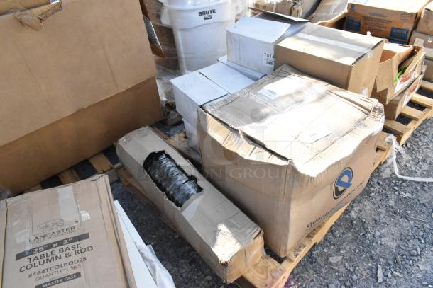 Boxes of brand new scratch and dent items, including 7014 hot dog holders and a black anti-fatigue floor mat, on pallets.