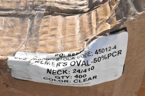 Brown cardboard box with a label marked "PO: 98630," "STOCK CODE: 45012-4," "NECK: 24/410, QTY: 400, COLOR: CLEAR."