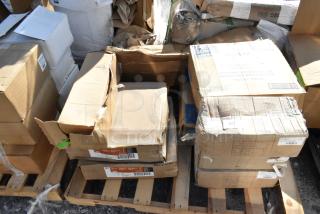 Boxes containing new scratch and dent items on a pallet, including Dart lids, 3M pads, and stanchions, with visible labels.
