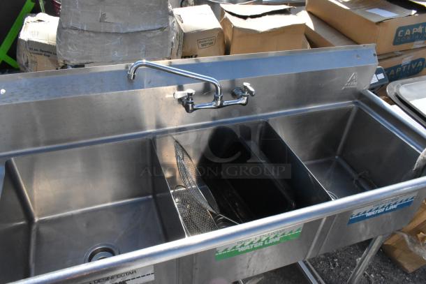 Stainless steel 3 bay sink with left side drain board, includes dual faucet and labeled compartments, used condition.