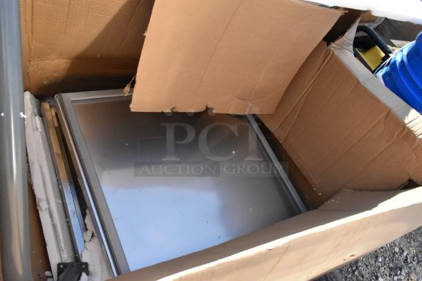 Box containing various auction items, including a 334FS500TW scale and 3803050 cotton candy cones, visible under cardboard.