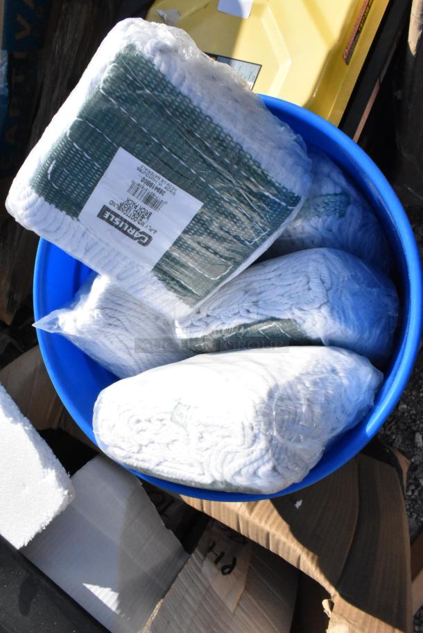 Blue poly bucket containing Carlisle 369418B00 Brick Pack mop heads, sealed in plastic.