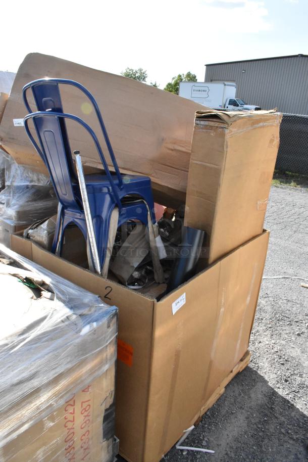 12 brand new scratch and dent Tolix style metal chairs in original packaging, stacked in a cardboard box.