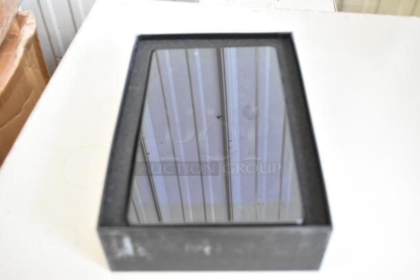 Three various tablets in a box, new condition, black frames. Auction includes multiple brands.