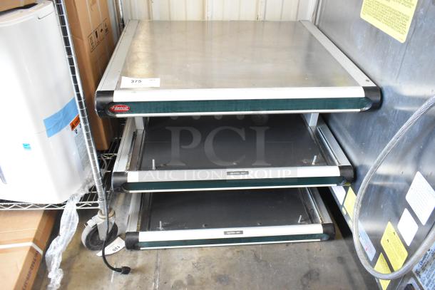 Hatco metal commercial countertop 2-tier warming display case, 115 volts, 1 phase, with caution labels, in used condition.
