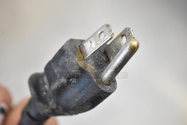 A close-up of a worn electrical plug for a Hatco Commercial Countertop Warming Display Case, 115 volts, 1 phase.