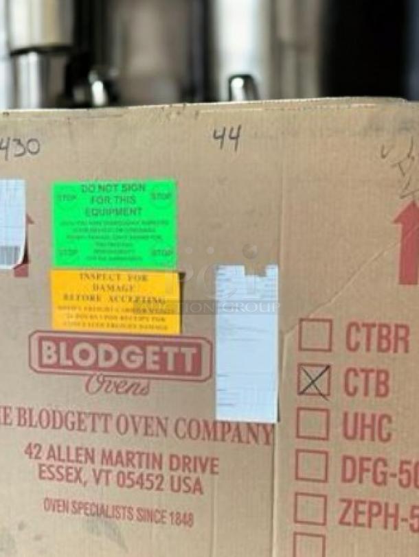 Brand new Blodgett CTB countertop convection oven in packaging; features natural gas/electric, 120V. Labels indicate inspection and origin.