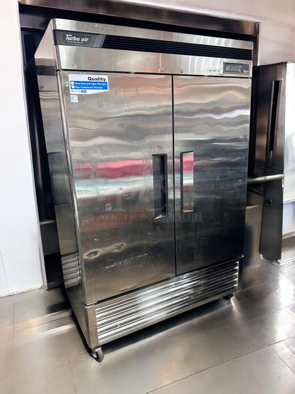 Turbo Air TSR-49SD two-door reach-in refrigerator, excellent condition, 115V, fully tested, stainless steel, warranty labels visible.
