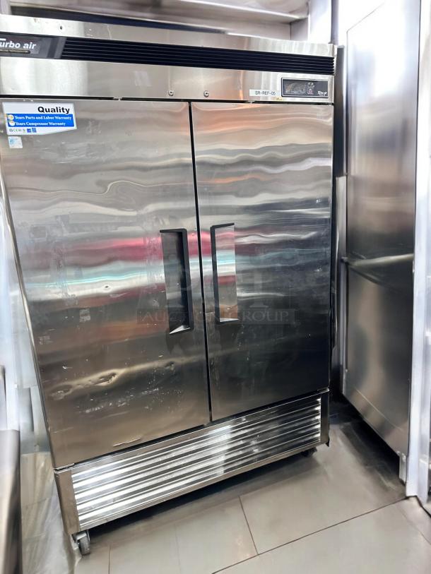Turbo Air TSR-49SD two-door reach-in refrigerator in excellent condition, stainless steel, with quality and warranty labels.