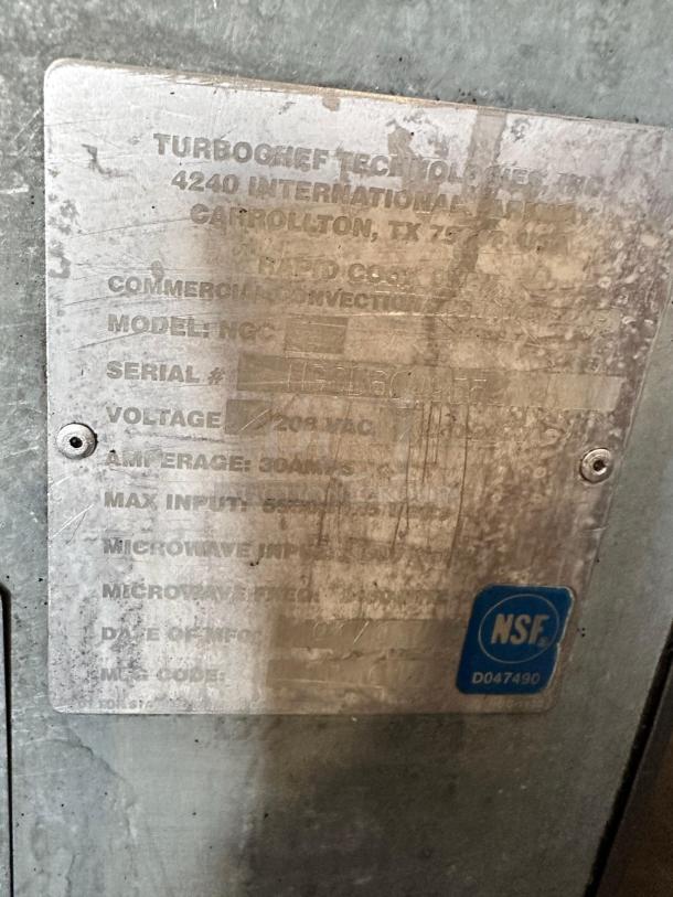 Metal label on TurboChef Tornado NGC high-speed convection oven showing model, serial number, and 208V AC voltage.