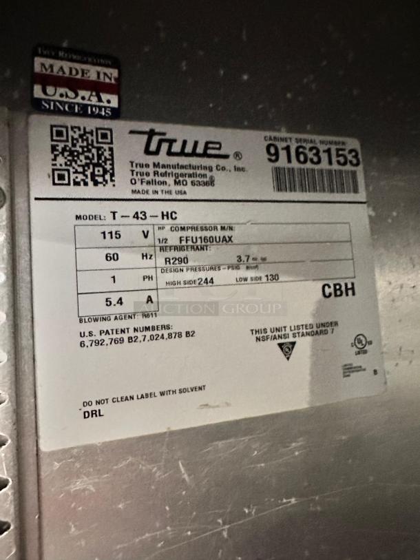Label on True T-43-HC refrigerator showing model, voltage, and refrigerant details. Made in USA. Serial number: 9163153.