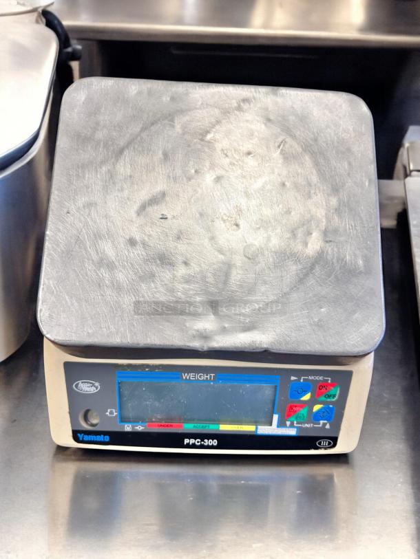 Yamato PPC-300 digital scale in excellent condition, fully tested and working. Features clear display, control buttons, and sturdy surface.
