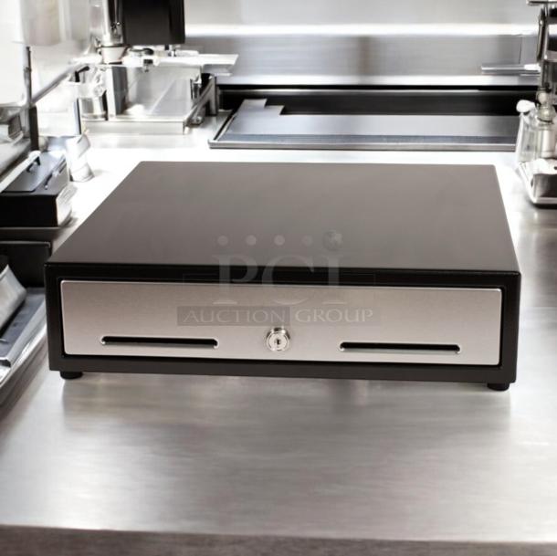 APG cash drawer model VBS579-BL1616 in excellent condition, fully tested, with dual slots and central lock, on stainless surface.