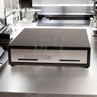 APG cash drawer model VBS579-BL1616 in excellent condition, fully tested, with dual slots and central lock, on stainless surface.