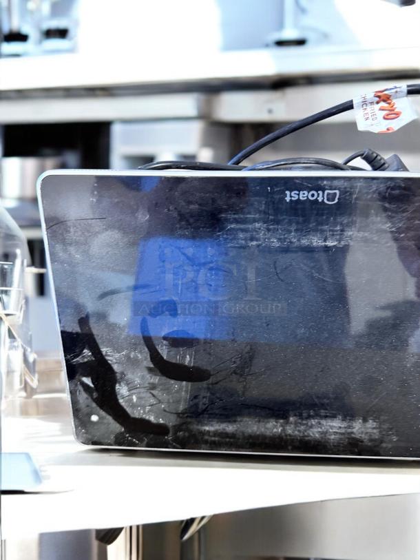 Toast POS Touchscreen System in excellent condition. Fully tested and working, includes three bundles. Visible branding on device.