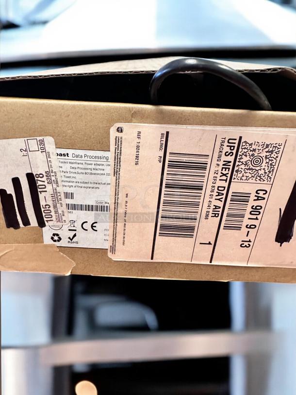 Box containing Toast POS Touchscreen System bundle in excellent condition, shipping labels visible.