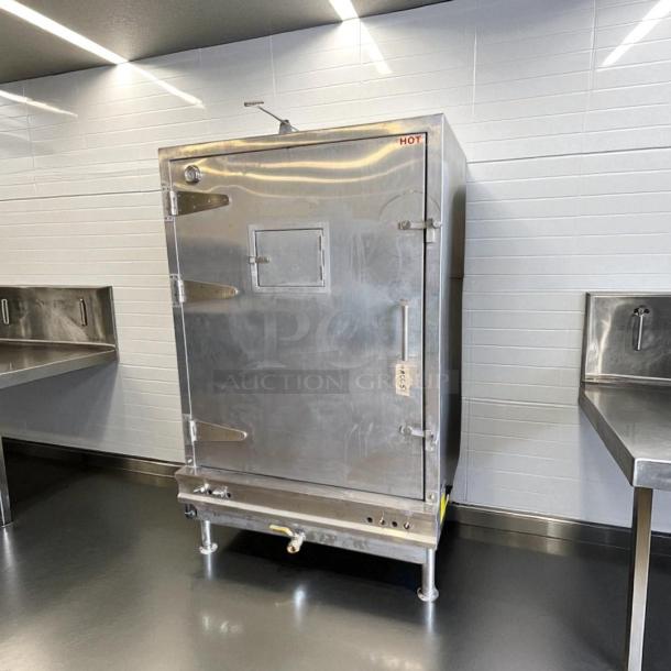 Stainless steel commercial oven in a kitchen setting, labeled "HOT." Features include a viewing window and heavy-duty hinges.