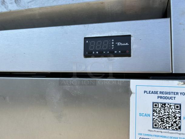 True T-49F-HC 2-door stainless steel reach-in freezer. Digital display, model and brand label visible. Excellent condition.