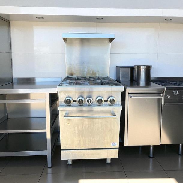 Cooler Depot TC-R24 4-burner commercial oven range, stainless steel, tested working, clean condition, visible control knobs.