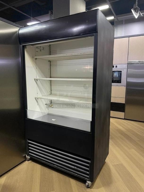 True TAC-48 air curtain merchandiser in excellent condition, 208/230V, fully tested, features shelves and cooling vents.