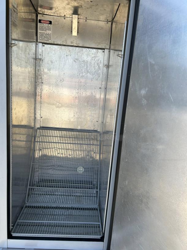 Economy Series EF1A-FS commercial freezer, single door, excellent condition, fully tested, 115V. Interior shelves visible.
