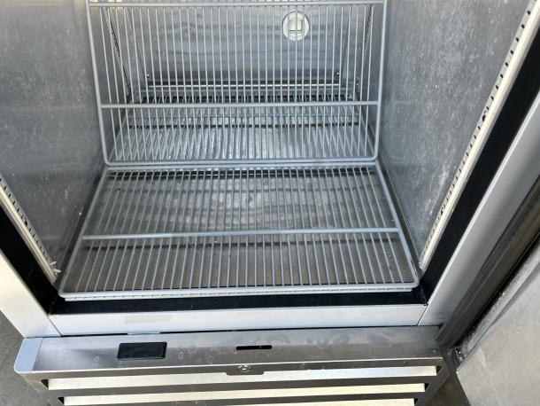 Economy Series EF1A-FS single door commercial freezer, silver interior, gray shelves, excellent condition, 115V, fully tested.