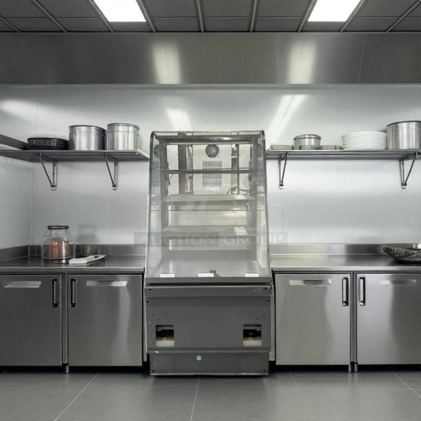 Structural Concepts dry display case, excellent condition, stainless steel finish, tested and working, commercial kitchen setting.