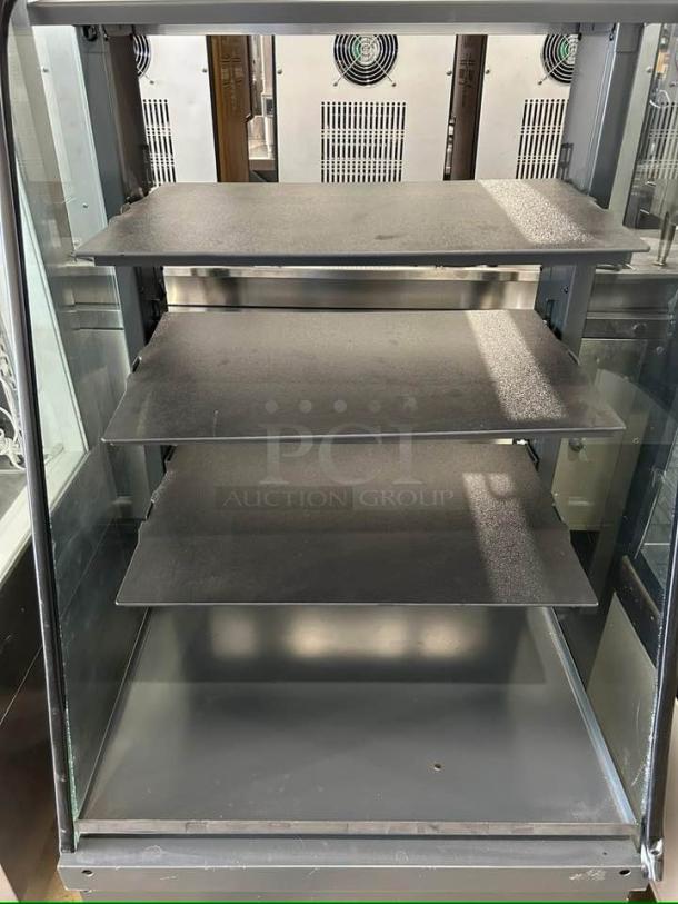 Structural Concepts dry display case in excellent condition, four adjustable shelves, clear glass panels, tested and working.