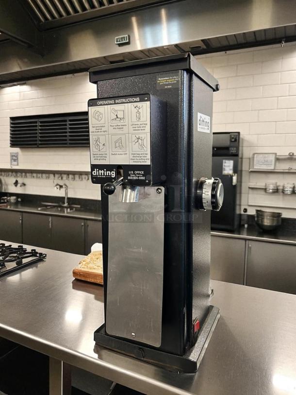 Ditting KR1203 commercial coffee grinder in excellent condition, stainless steel finish, operating instructions label visible.