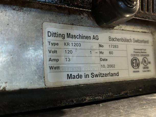 Ditting KR1203 coffee grinder label showing model, type, voltage, amp, and manufacturing date. Made in Switzerland.