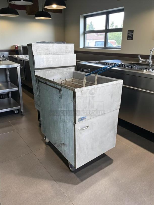 Pitco 65C+S 65 lb natural gas fryer, floor model, in excellent condition, fully tested and working, seen in a commercial kitchen.