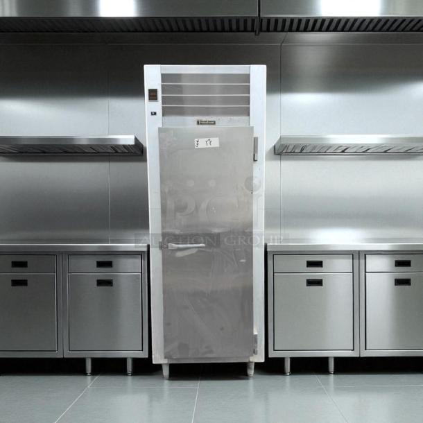 Traulsen G10010 commercial refrigerator, excellent condition, stainless steel, 115V, fully tested and working in a kitchen setting.