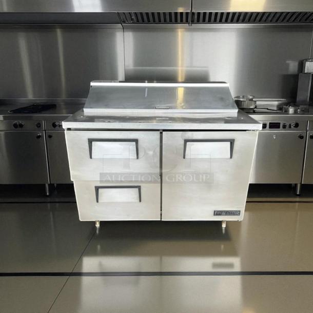 True TSSU-48-12D-2 prep table in excellent condition, 48" wide, stainless steel, two doors, fully tested, 115V.