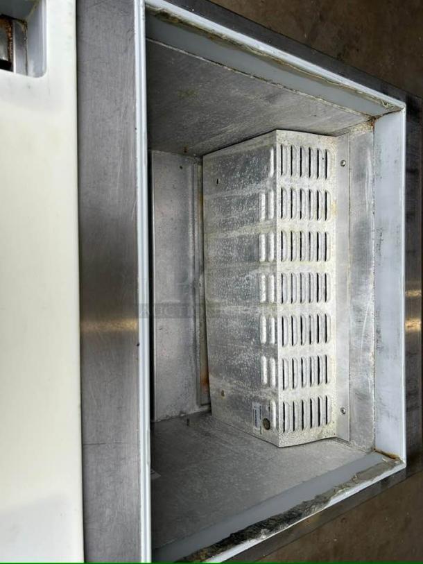 Continental SW27-12M Mighty Top Sandwich Prep Unit interior view, stainless steel, shows refrigeration unit, fully tested.