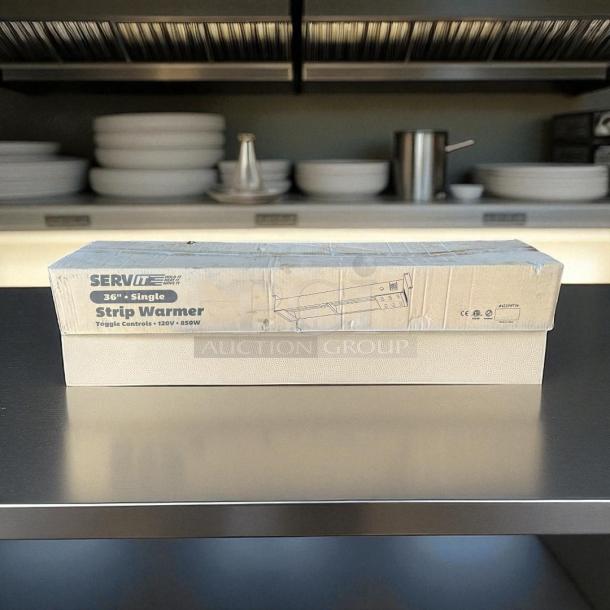 Brand new ServIt 36" strip warmer in packaging, 120V, 850W, with single toggle control. Packaging label visible.
