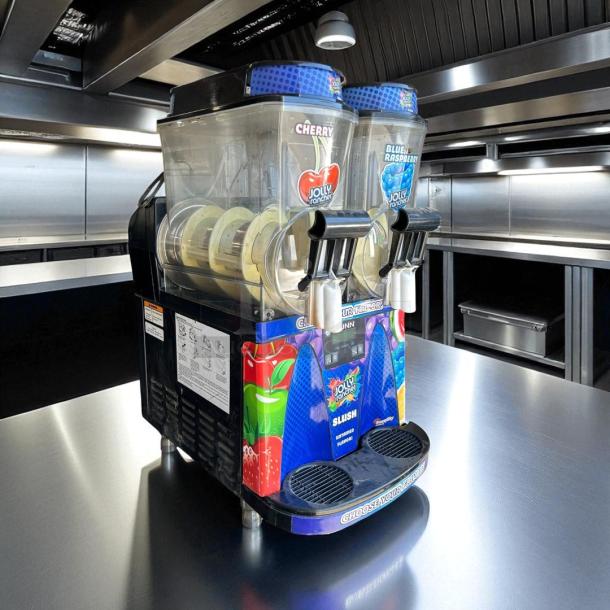 Bunn Ultra-2 frozen drink machine, excellent condition, dual tanks, Cherry and Blue Raspberry flavors visible, 120V, fully tested.