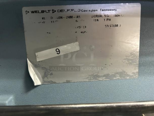 Label of a Delfield D4460NP-24M refrigerated sandwich prep table, showing Welbilt branding and serial number details.