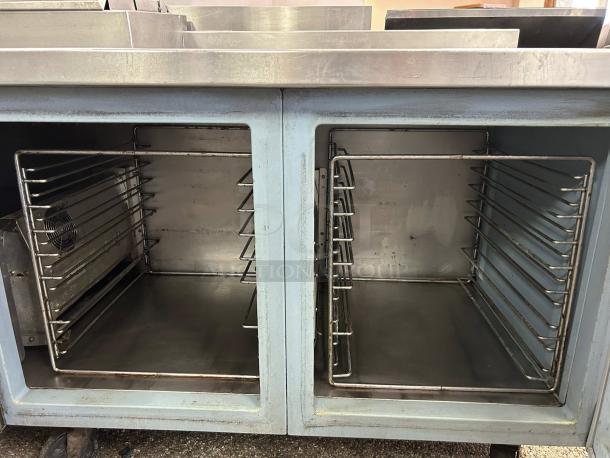 Delfield 3 Door Pizza Prep Table, excellent condition, stainless steel interior, multiple shelves, tested and working.