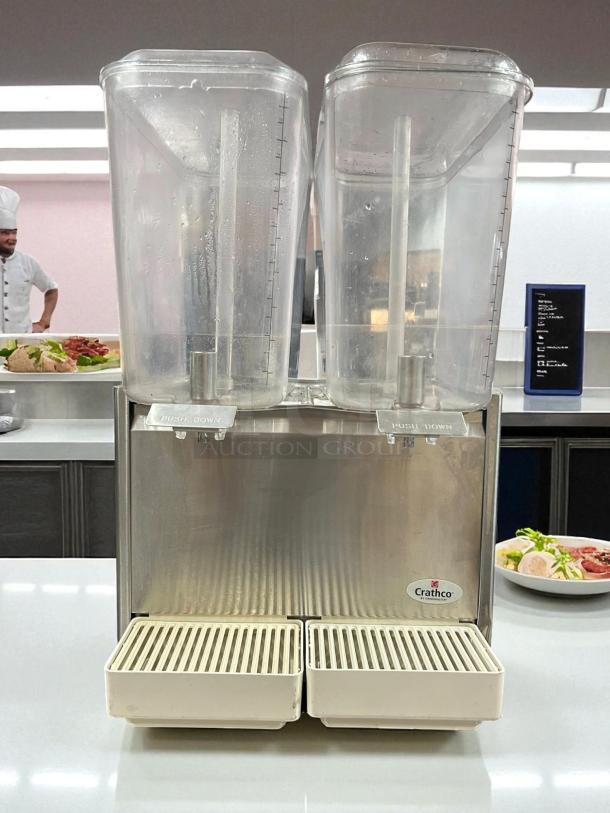 Crathco D25-3 cold beverage dispenser in excellent condition with dual transparent containers, fully tested and operational.