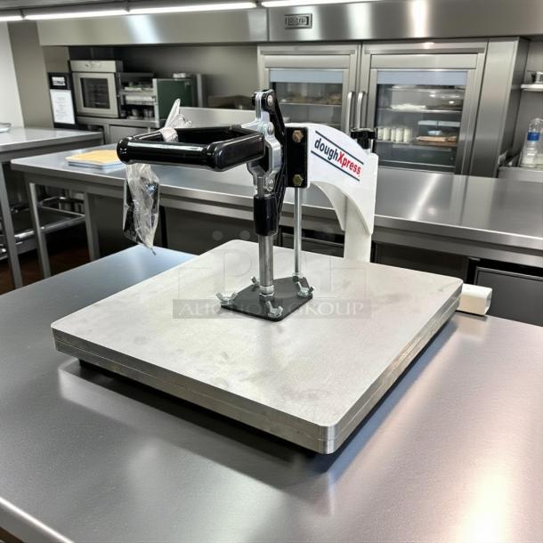 DoughXpress pizza dough press in excellent condition, manual model, fully tested and working, on stainless steel counter.