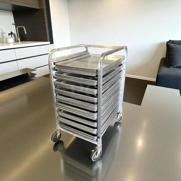 Like new half-size bakery speed rack, sheet pans not included, great condition, sturdy metal construction, casters for mobility.