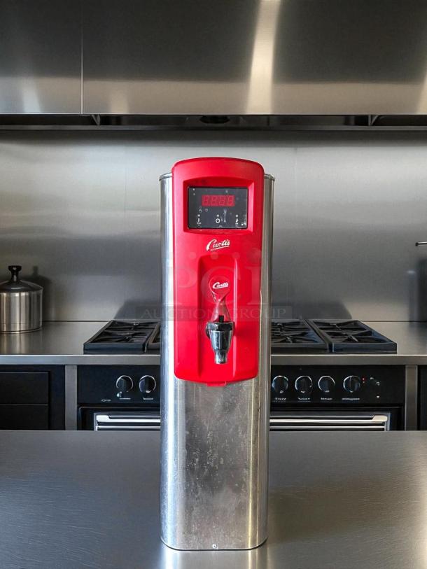 Wilbur Curtis WB5N hot water dispenser, excellent condition, 5-gallon capacity, red and stainless steel, 120/220V, fully tested.