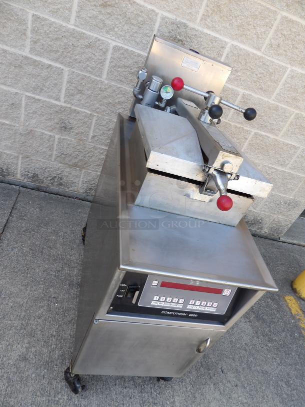 Henny Penny 600 stainless steel gas pressure fryer on casters, excellent condition, 80,000 BTU, commercial controls visible.