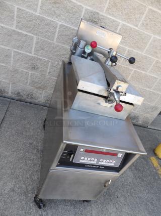 Henny Penny 600 stainless steel gas pressure fryer on casters, excellent condition, 80,000 BTU, commercial controls visible.