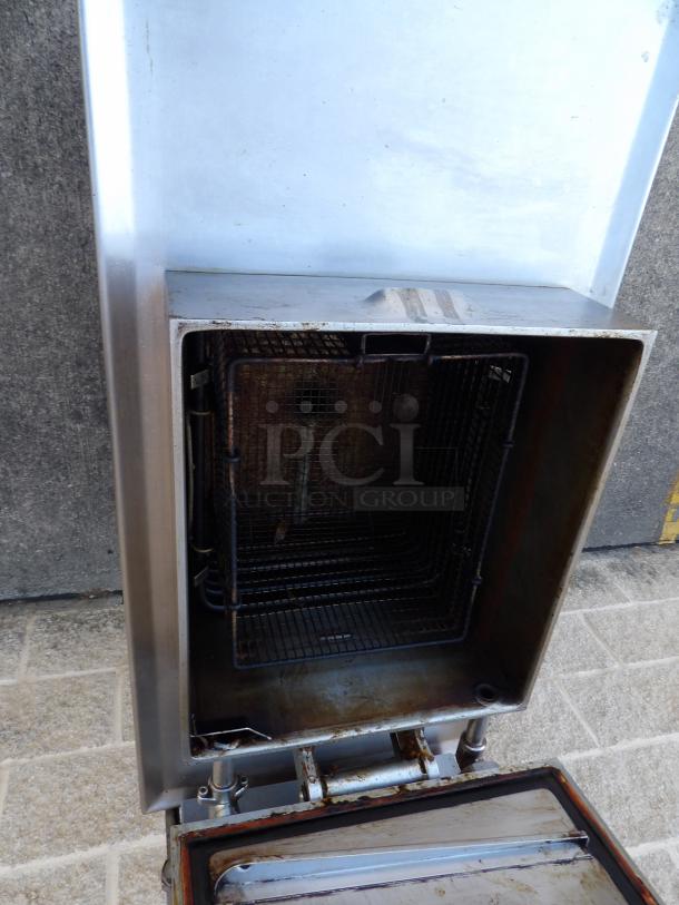 Henny Penny 600 stainless steel pressure fryer, natural gas, commercial casters, 80,000 BTU, in excellent condition.
