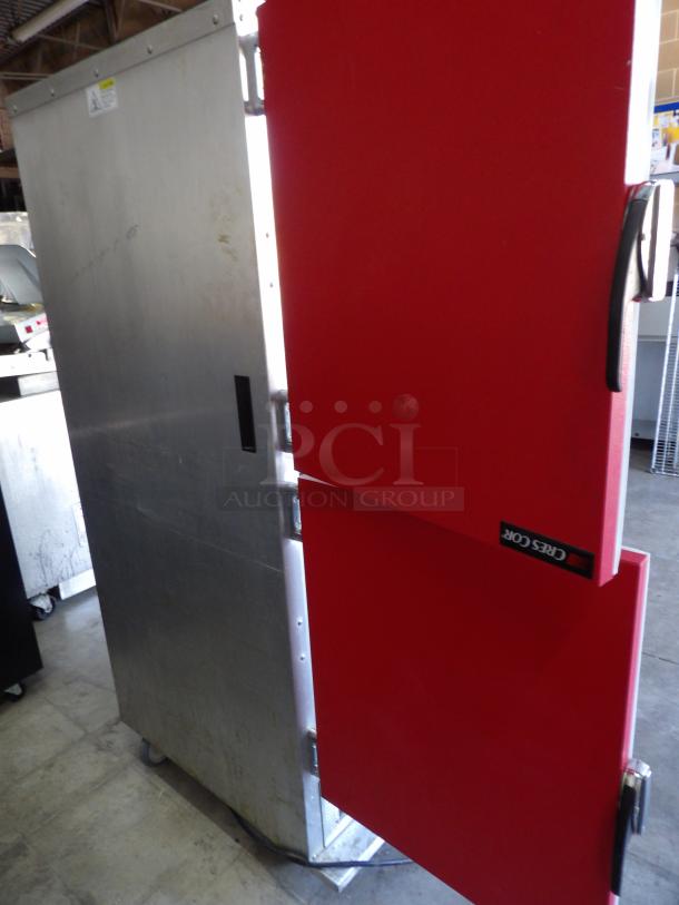 Crescor H-135-UA-11R heated cabinet with red doors on commercial casters. Metal construction, 120 volts, powers on and heats.