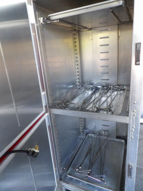 CresCor metal heated cabinet, model H-135-UA-11R, on casters. Interior racks visible, 120 volts, powers on and heats.