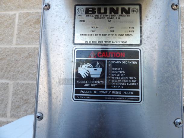 Bunn O-Matic ST-15 Commercial Coffee Brewer, stainless steel, with 2 upper warmers. Caution labels visible.